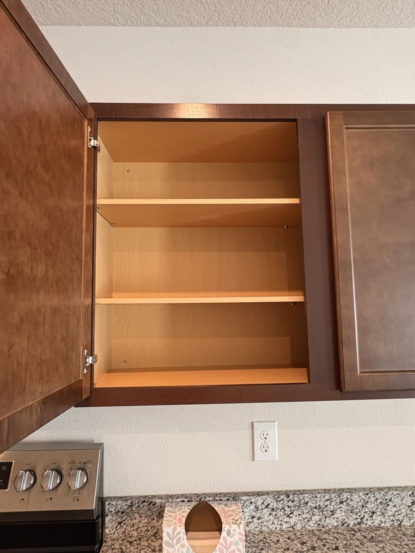 Empty kitchen cabinet interior, wiped clean after move-out